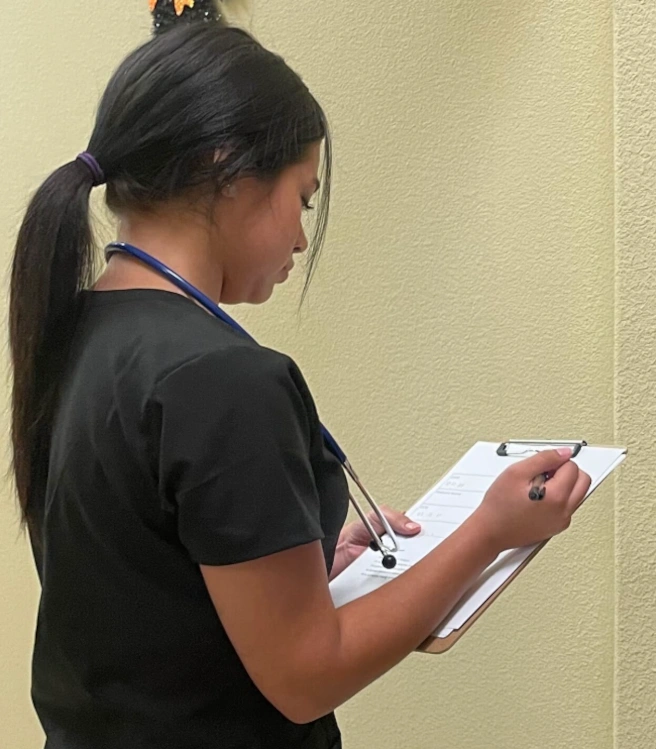student reviewing patient paperwork